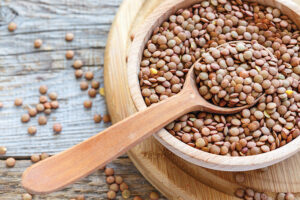 Lentils,And,Spoon,In,A,Wooden,Bowl,Close,Up,On 0