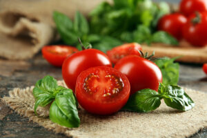 Cherry,Tomatoes,With,Basil,On,Wooden,Table,Close,Up 0